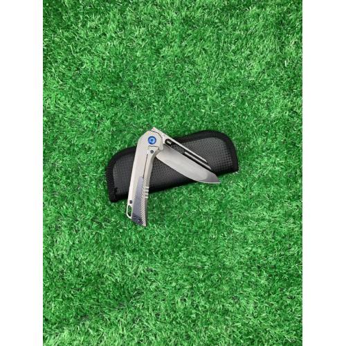 Introducing the new M390 Tyrannosaurus DLC Titanium Folding Knife, featuring a sleek white handle and a striking black b