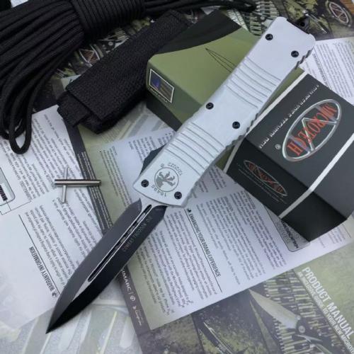 Introducing the Replica Microtech Dragon Double Blade: a masterful fusion of precision engineering and striking design. 
